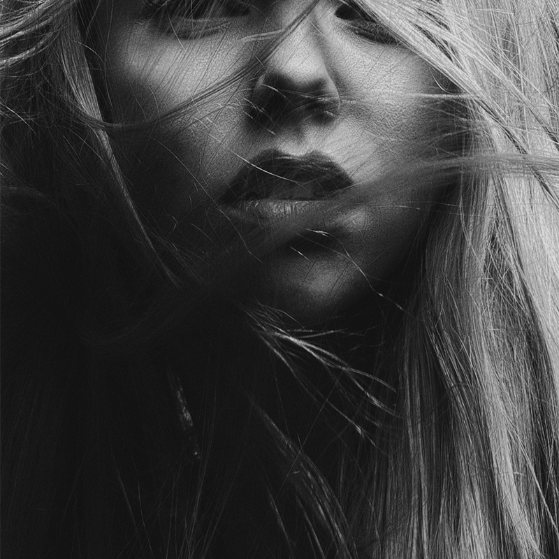 black and white photo of blond haired woman with wispy hair